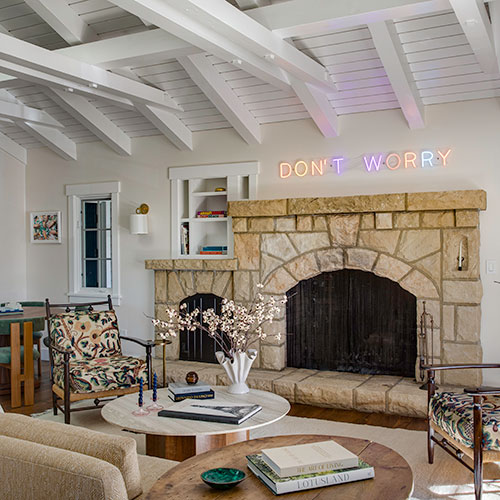 Montecito treehouse living room designed by Santa Barbara interior designer with vaulted ceilings, custom seating, and forest views