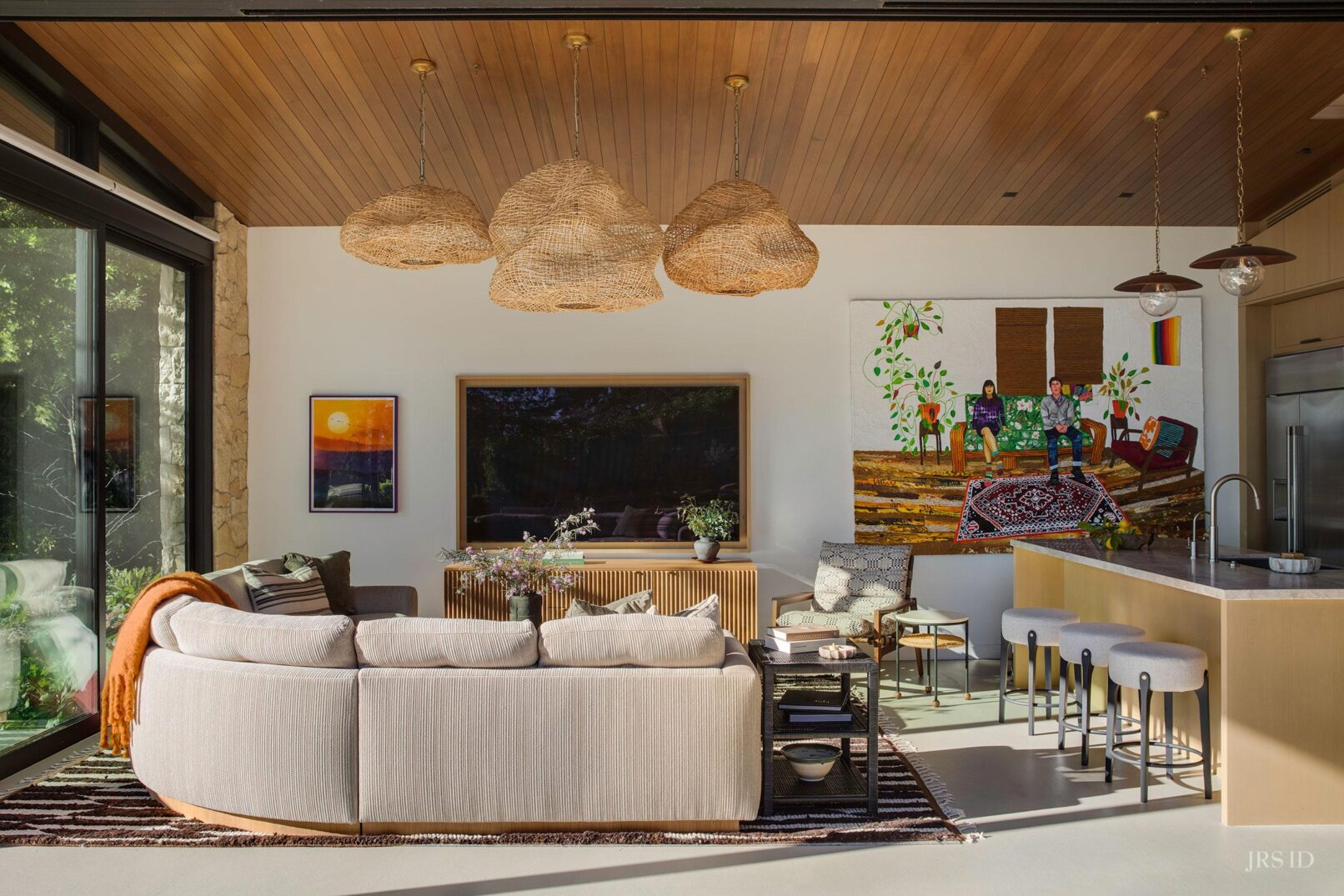 Open-concept living room and kitchen with custom furnishings and natural materials at the Eucalyptus Hill ADU Residence in Montecito.